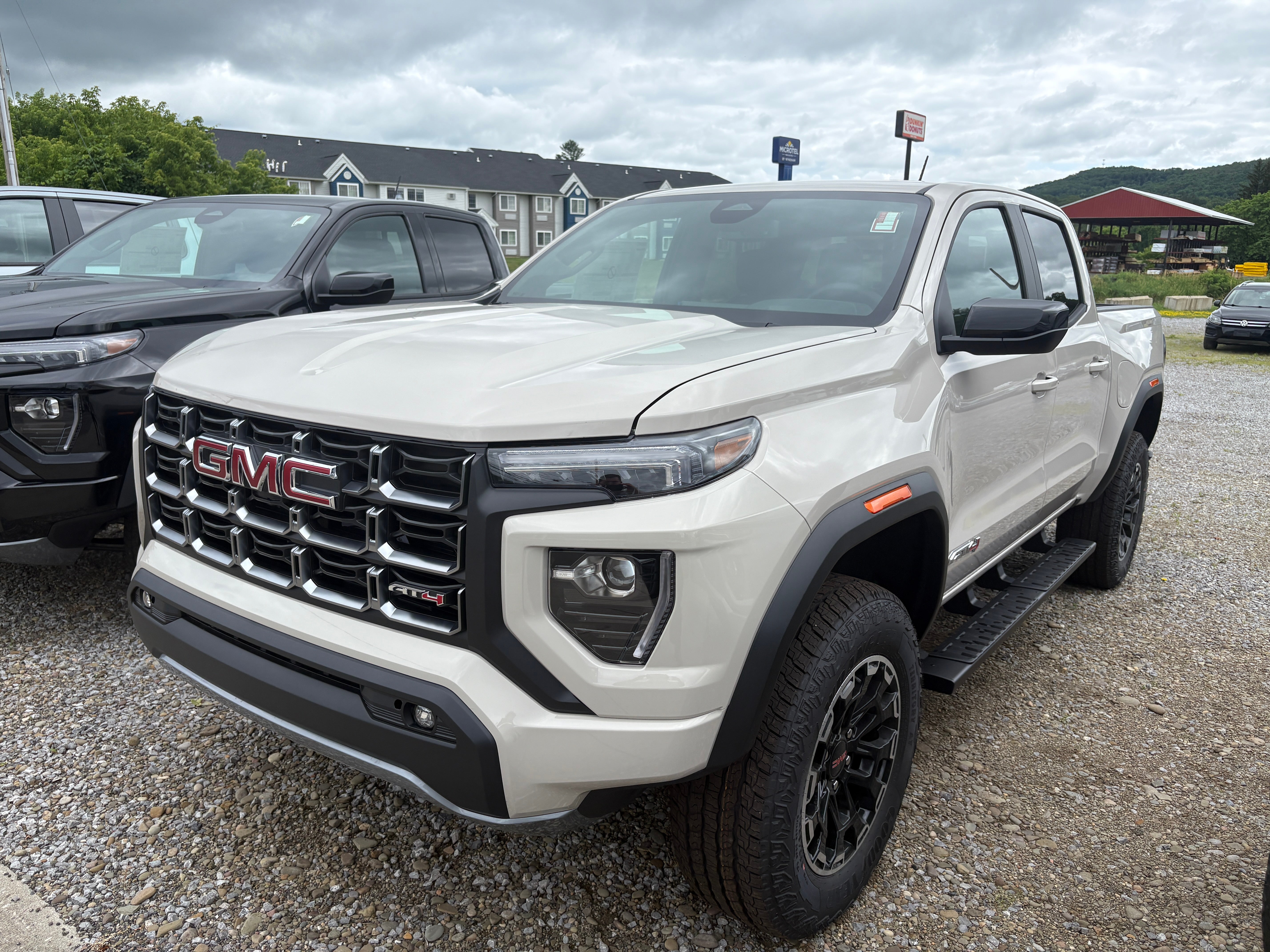 2026 GMC Canyon AT4 in Coastal Dune — front three-quarter view