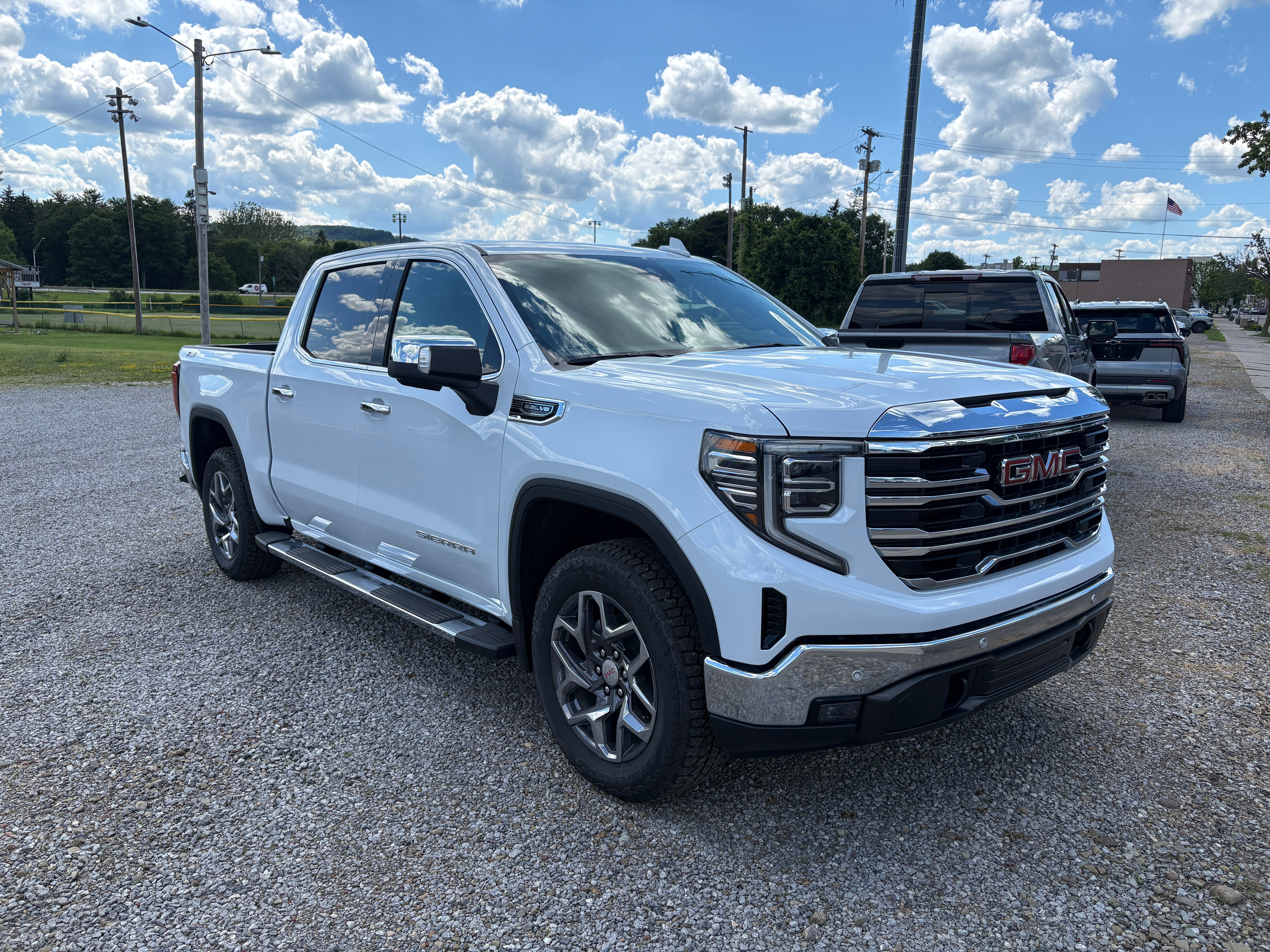 2026 GMC Sierra 1500 SLT in Glacier White Tricoat — front three-quarter view